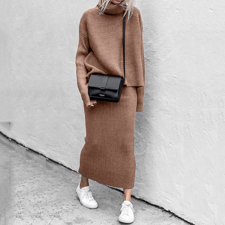 Close-up of a women's knitted coord set, highlighting the cozy texture of the pullover and ribbed skirt.