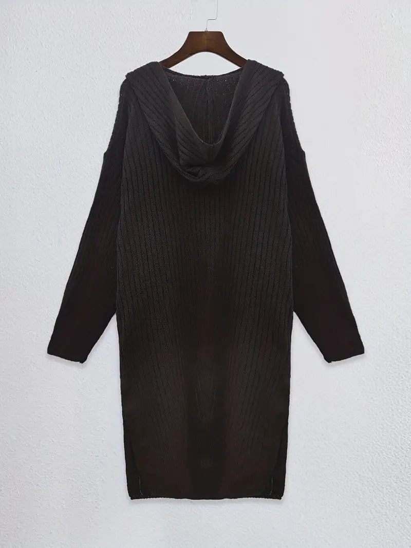Fashionable woman modeling a warm, long knitted cardigan, cozy & stylish for autumn/winter outfits.