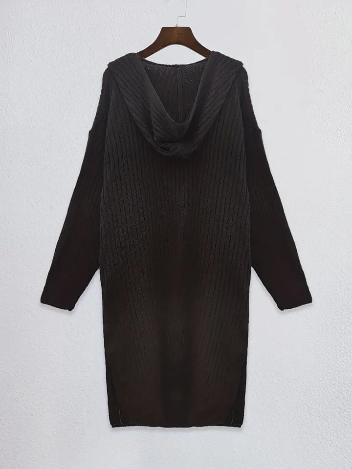 Fashionable woman modeling a warm, long knitted cardigan, cozy & stylish for autumn/winter outfits.