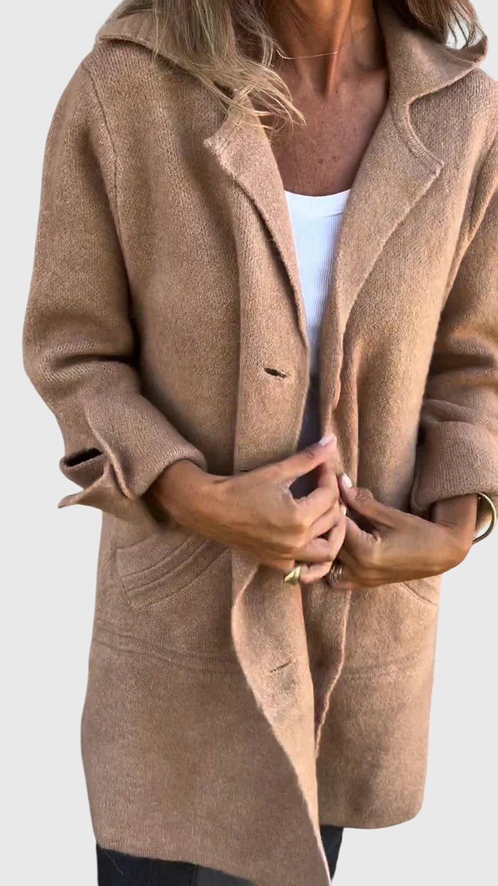 Woman in a cozy longline blazer enjoying fall fashion, perfect outerwear for seasonal layering.