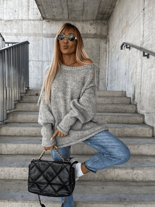 Soft knit off-shoulder top for women. Loose fit long-sleeve pullover, great for cozy winter fashion.