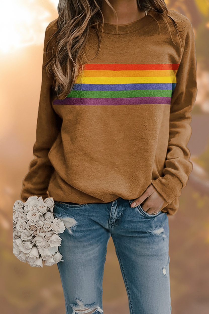 Women's relaxed fit rainbow striped pullover sweatshirt. Cozy long-sleeve top featuring bold colorful stripes.