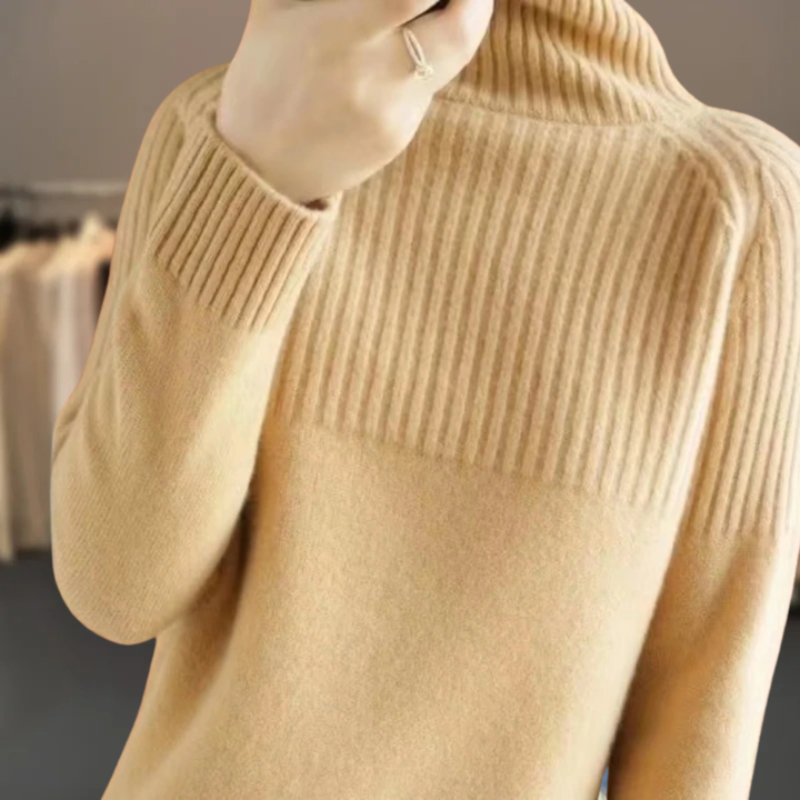 Close-up of a women's cozy ribbed turtleneck sweater, showcasing knit texture and high neck detail.