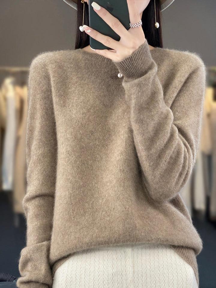 Woman wearing a cozy round neck pullover sweater for a relaxed fall look.