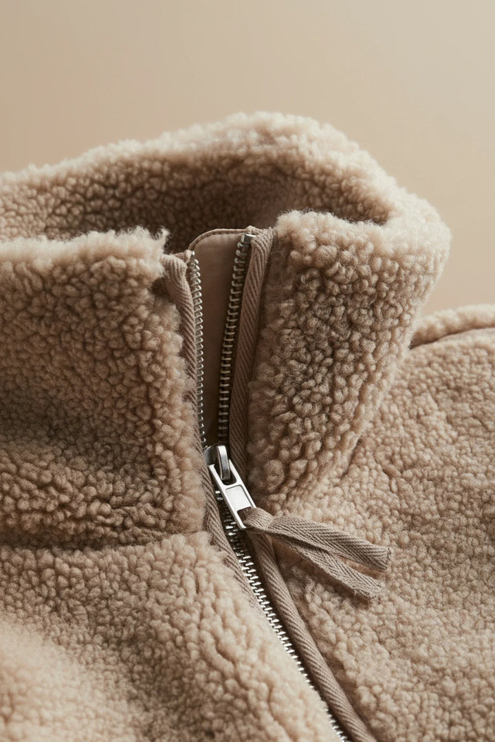Plush women's zip-up sherpa jacket. Cozy, warm, & comfortable everyday outerwear for autumn/winter fashion. High collar.