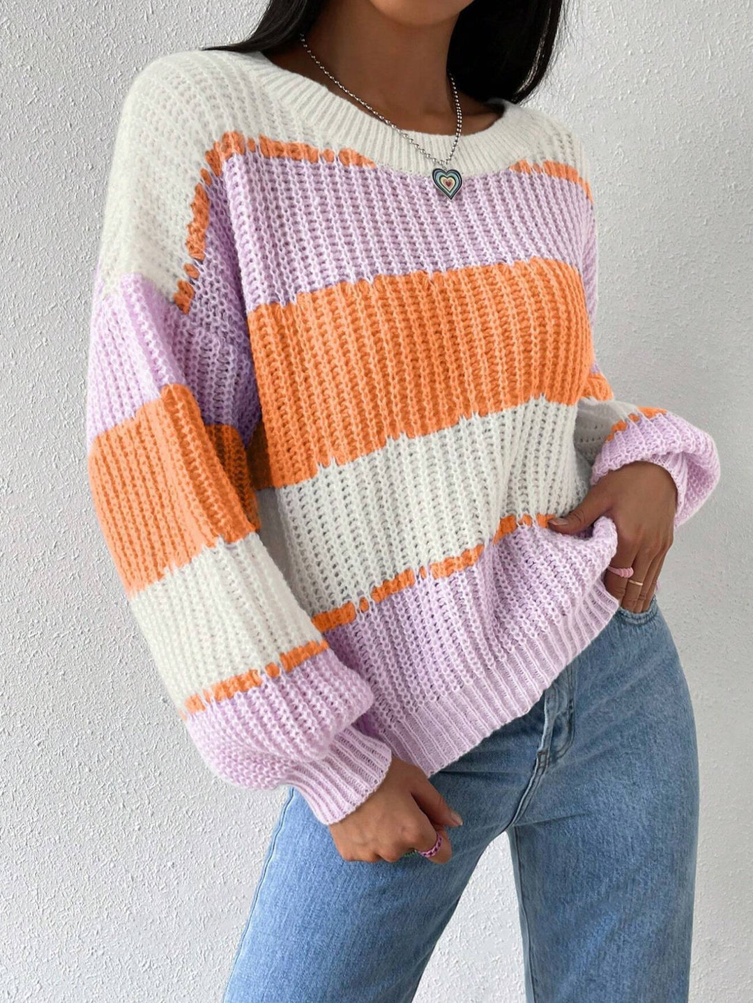 Full-length view of a model wearing a comfortable women's striped knit pullover sweater.