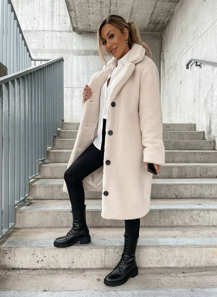Warm women's long teddy coat, ideal for winter outerwear. Elegant & cozy, a chic addition to fall fashion.
