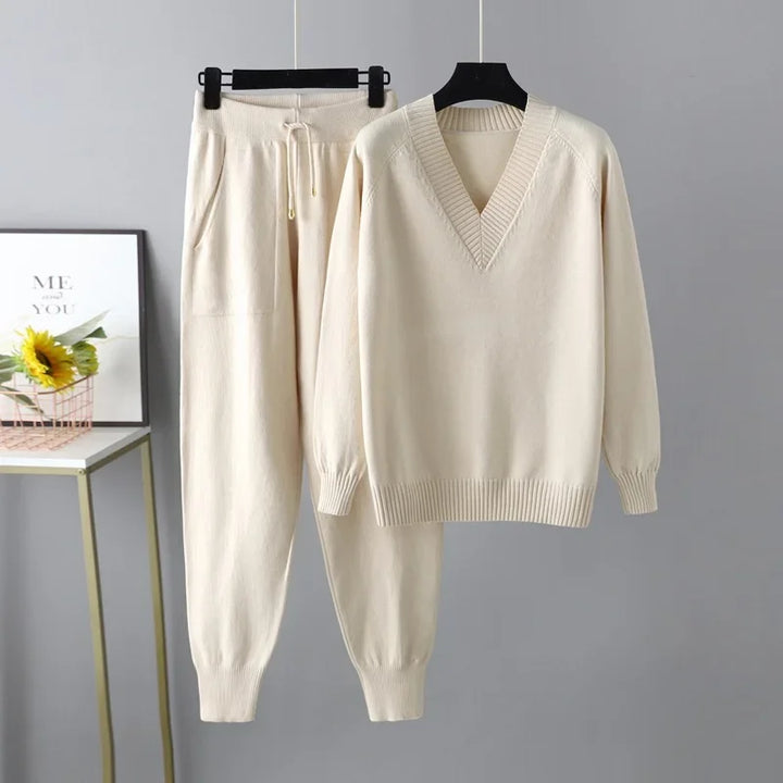 Women's cozy V-neck knit sweater and matching trousers set for elegant comfort. Perfect autumn loungewear.
