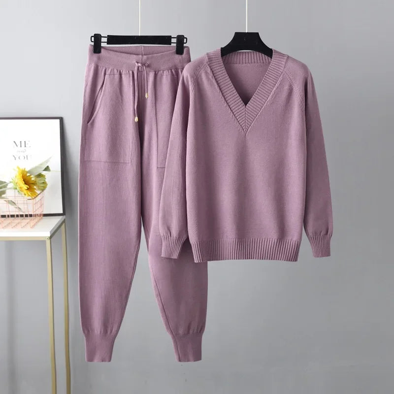 Elegant women's knit two-piece set: soft V-neck sweater & matching trousers. Cozy winter fashion.