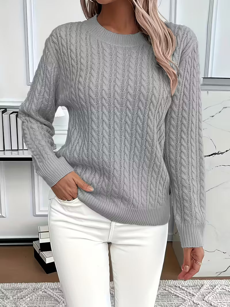 Soft knit women's crew neck sweater with cable patterns. Essential autumn layering piece for cozy style.