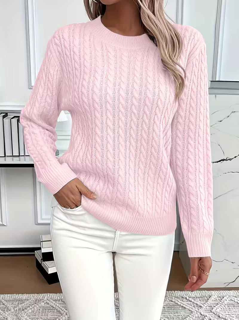 Women's crew neck cable knit sweater with ribbed cuffs & hem. Ideal for autumn layering & cozy fashion.
