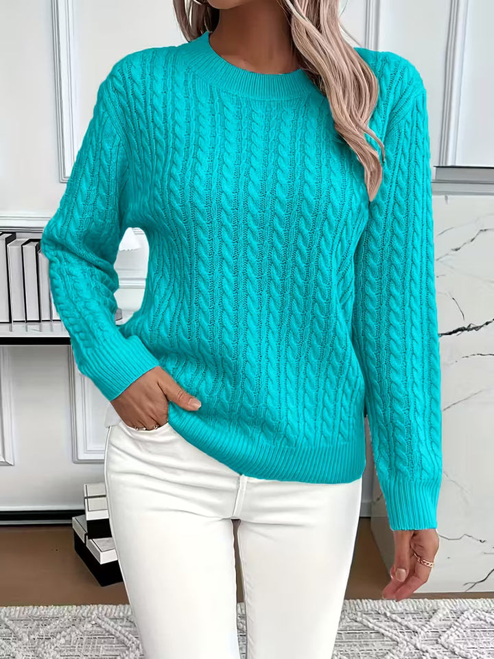 Cozy women's cable knit crew neck sweater, designed for warmth & comfort in autumn layering fashion.