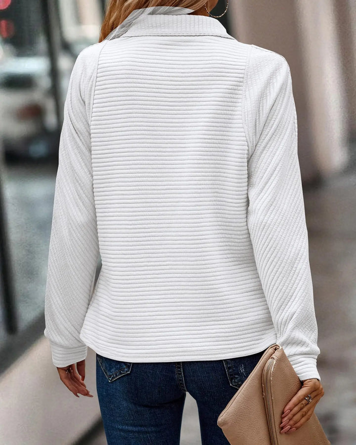 Women's half-zip pullover sweater for spring, highlighting its soft knit and relaxed fit