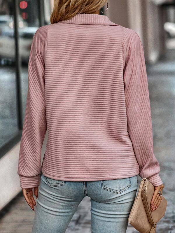 Women's half-zip pullover sweater in a light spring color, laid flat to show full design
