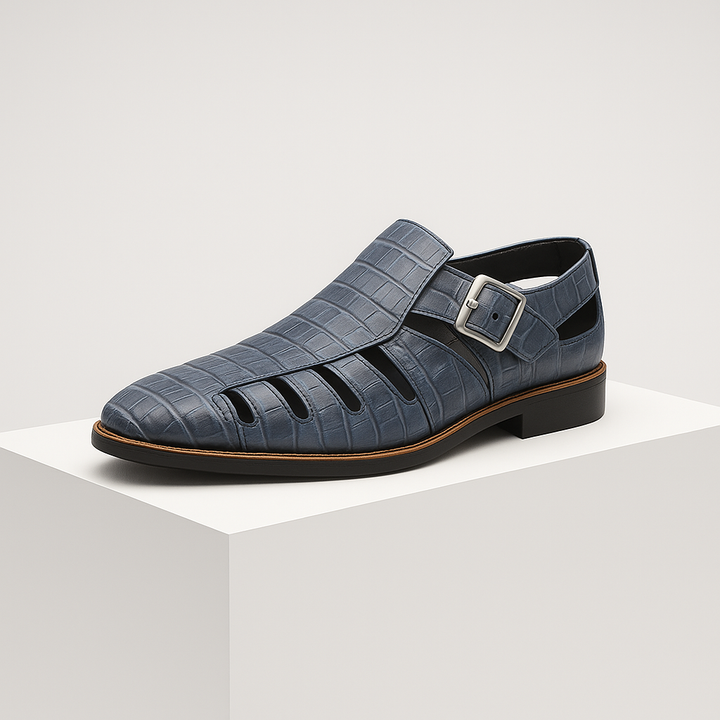 Close up of crocodile embossed leather texture on women's flat buckle sandals