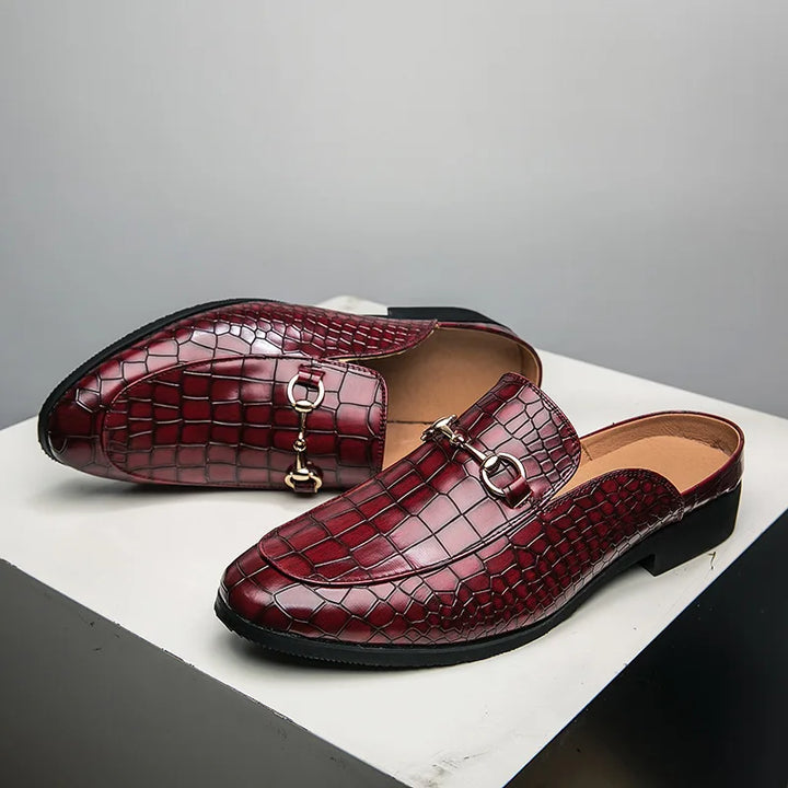 View of the sole of women's croc-embossed slip-on loafer mules, showcasing quality construction