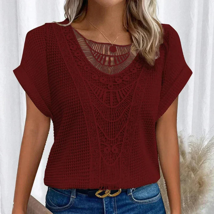 Ladies' fashion top: crochet-style blouse with elegant neck detail and comfortable short sleeves.