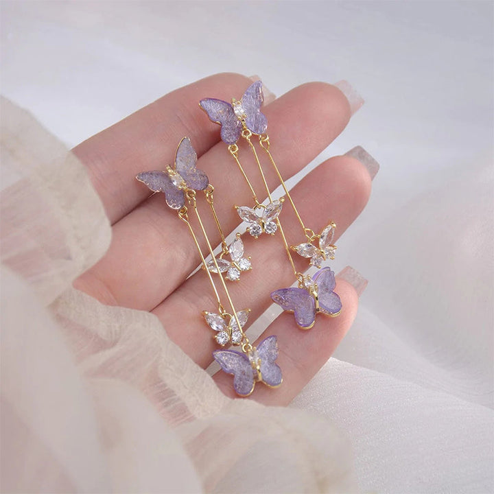 Stylish women's crystal butterfly dangle earrings featuring a delicate silver-tone tassel design