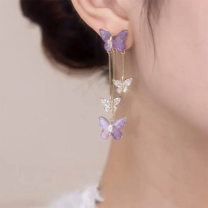 Front view of women's crystal butterfly tassel dangle earrings, highlighting gemstone brilliance