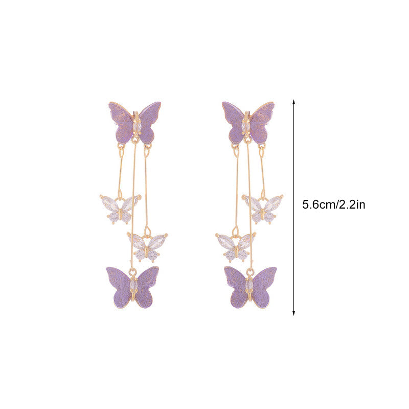 Detailed shot of a women's crystal butterfly earring, showing individual crystal placement and tassel