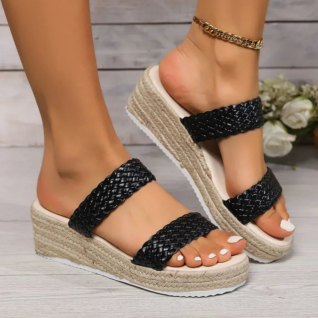 Comfortable slip-on black wedge sandals for women, designed for all-day wear and style.