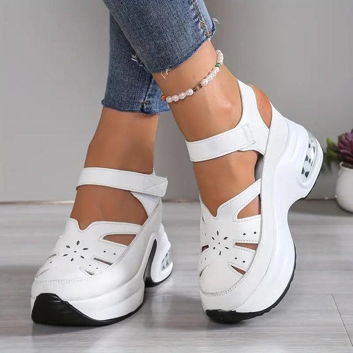 Women's cushioned wedge sandals with breathable cutouts, perfect for summer comfort.