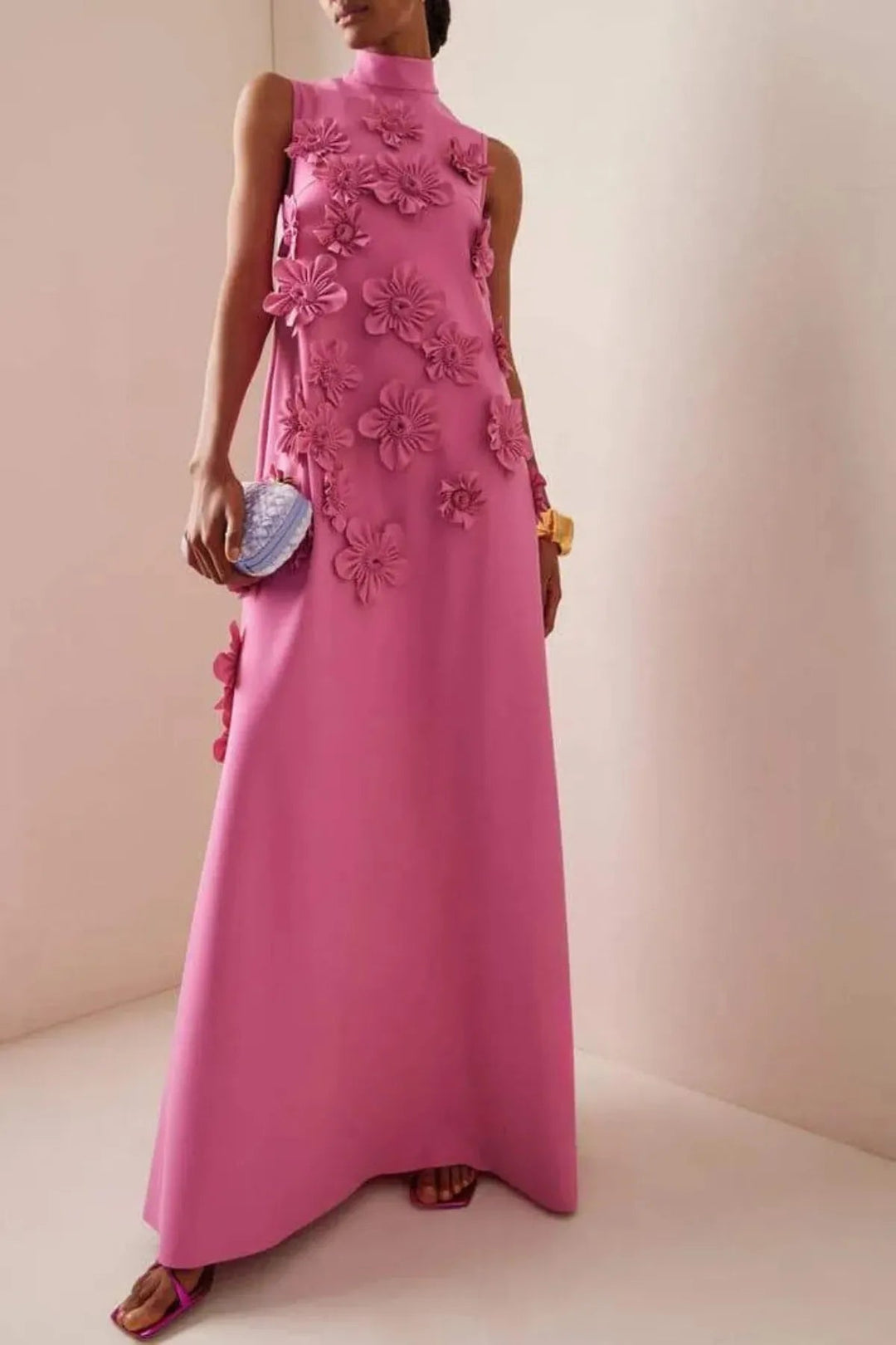 Women's dark pink floral 3D appliqué maxi dress. Elegant occasion wear, sleeveless, flowy summer style.