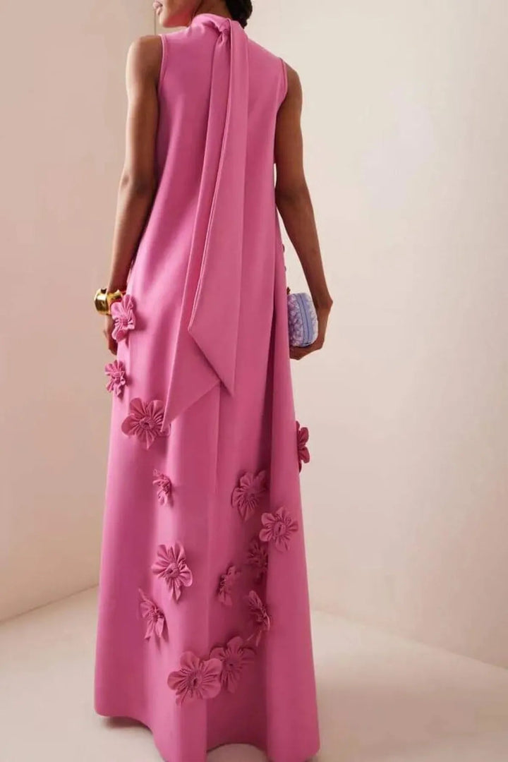 Statement women's dark pink maxi dress featuring delicate 3D floral appliqués. Structured yet flowy occasion wear.