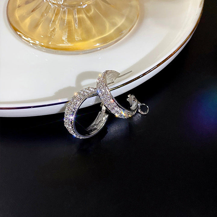 Delicate women's small hoop earrings, encrusted with shimmering rhinestones, elegant and stylish