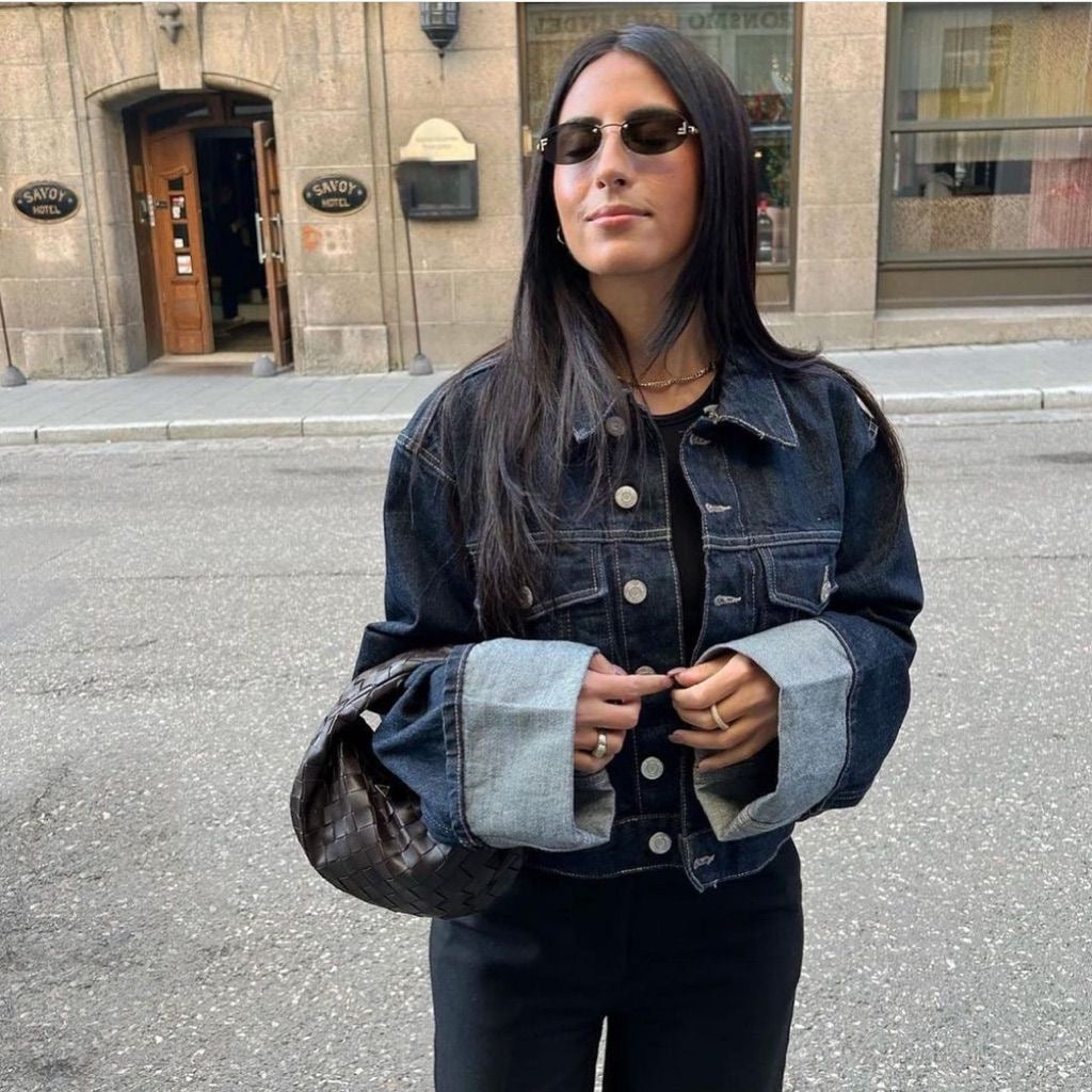 Model wearing a trendy women's cropped denim jacket and co-ordinating denim pants