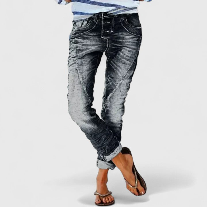 Woman wearing casual distressed wide leg jeans, showcasing their relaxed fit & trendy vintage denim style.