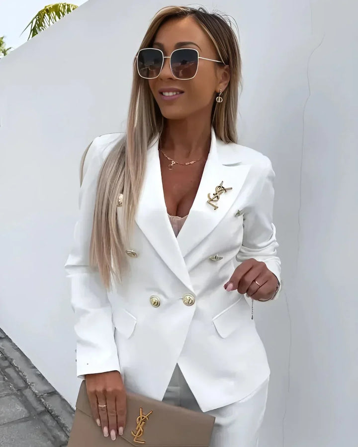 Women's tailored double-breasted blazer and matching professional trousers set.