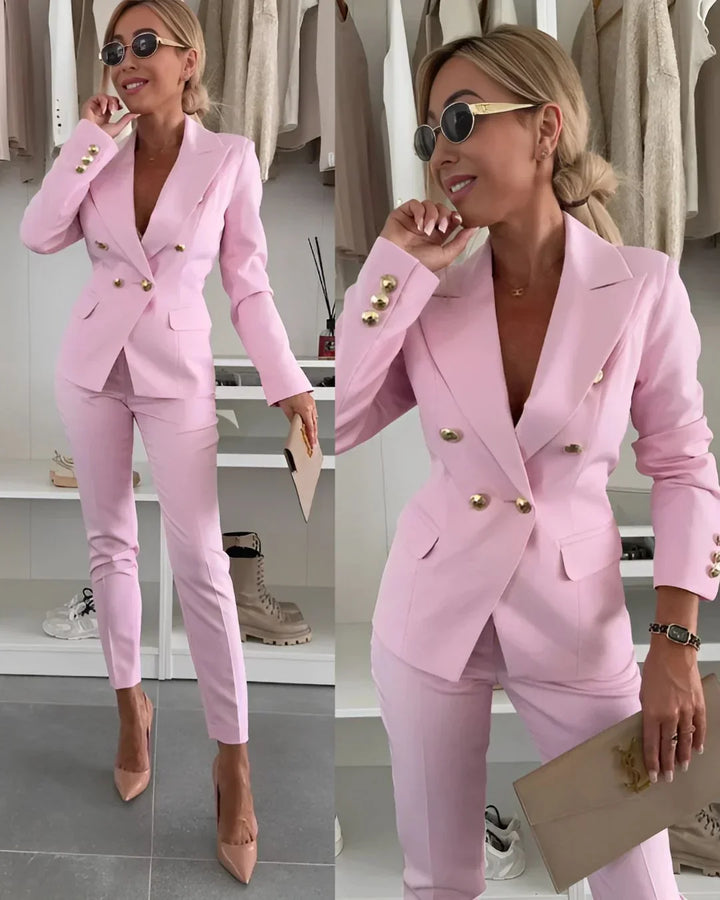 Formal two-piece women's suit, double-breasted blazer and classic tailored trousers.
