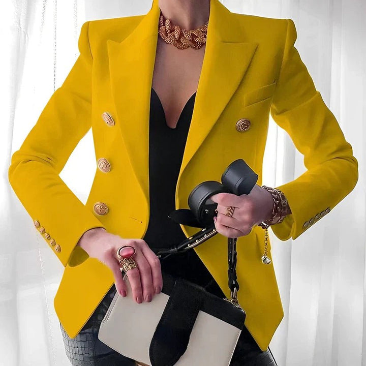 Sophisticated women's tailored blazer featuring a double-breasted front and eye-catching gold button details.