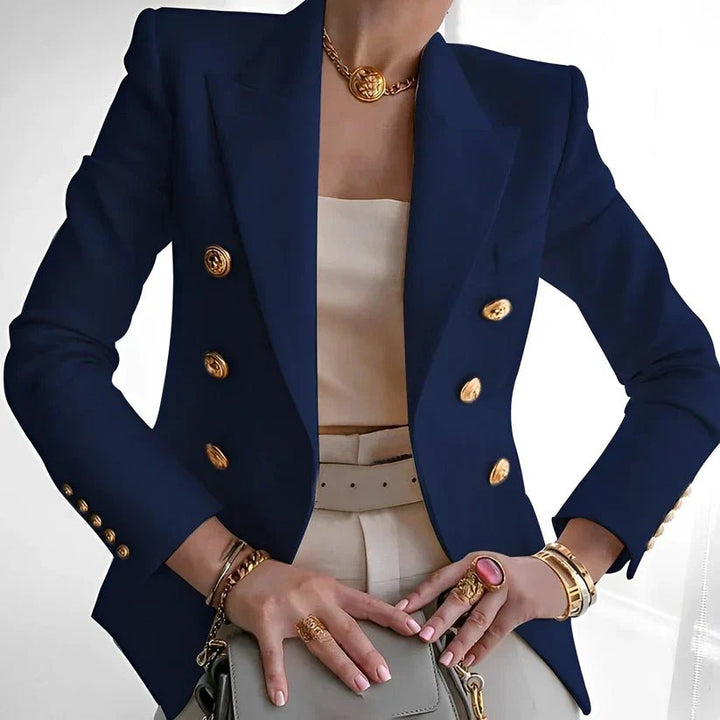 Fashionable women's double-breasted tailored jacket, structured for a power look, with elegant gold buttons.