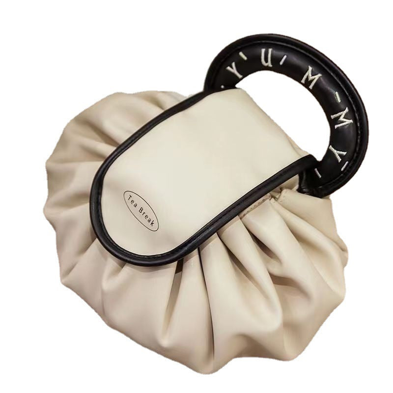 Women's drawstring makeup organizer, top view, highlighting the open main compartment