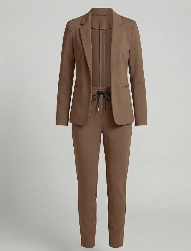 Close-up of the women's two-piece suit set fabric, highlighting comfort & quality. Modern, professional women's clothing.