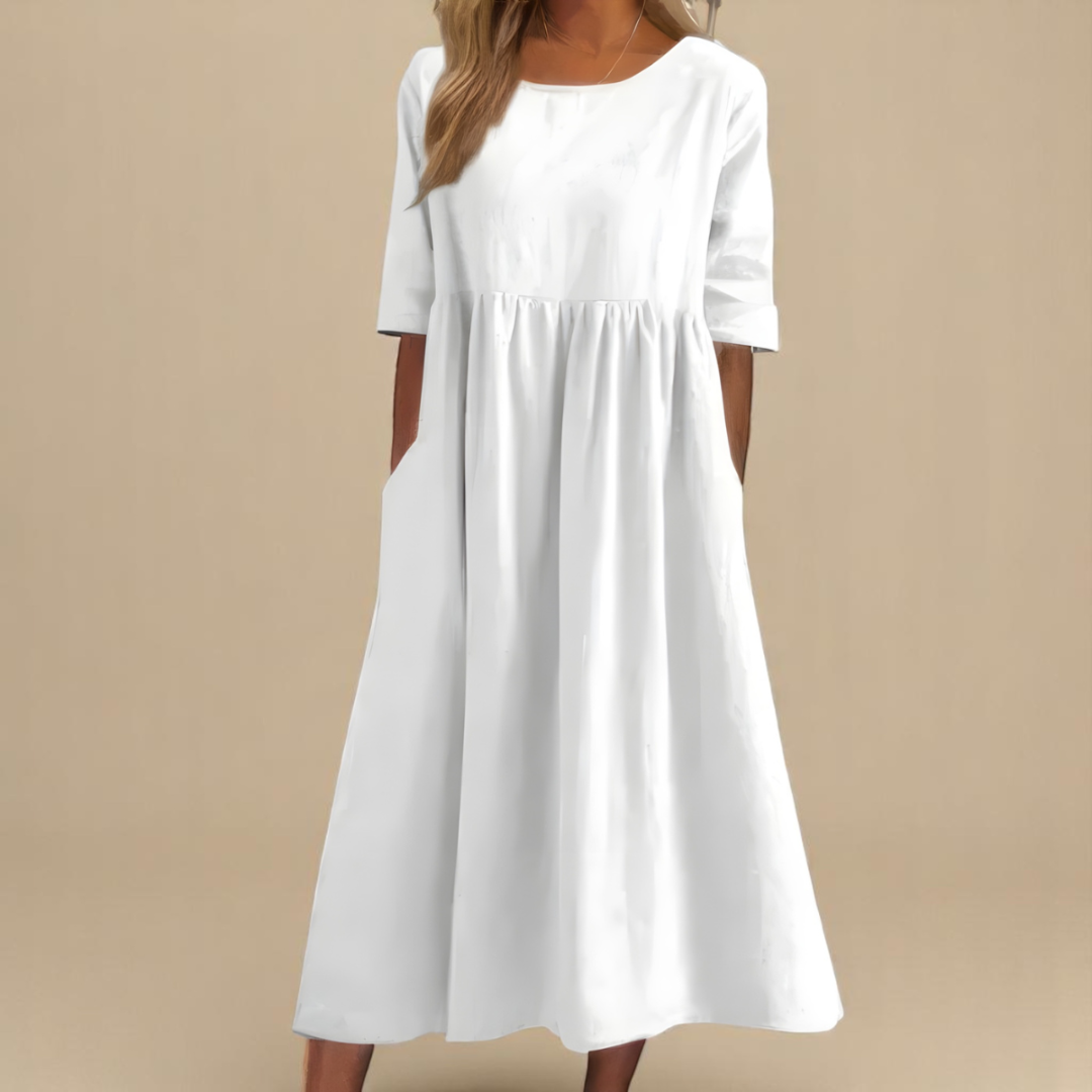 Flowy women's midi dress with a flattering gathered empire waist, half sleeves, scoop neck, and pockets.