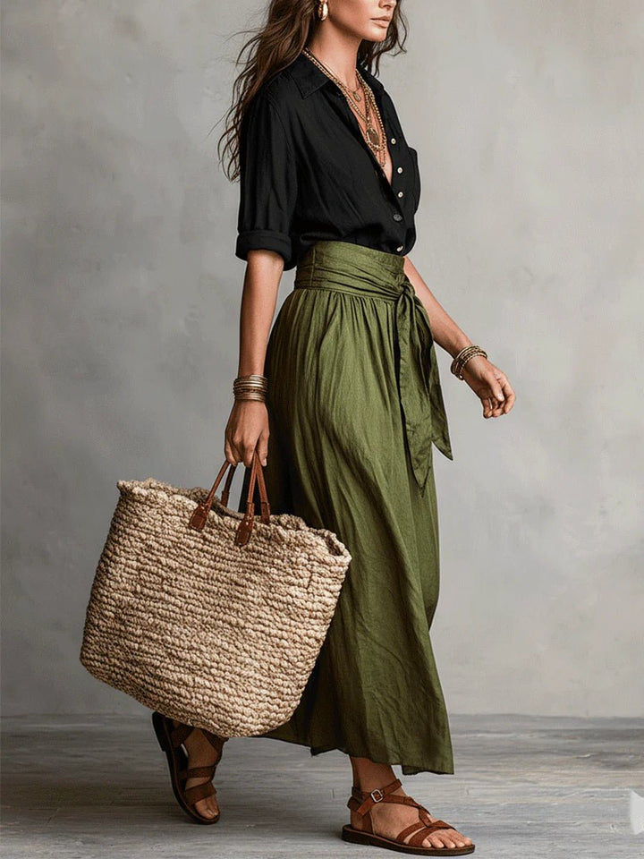 Chic women's two-piece maxi skirt set, featuring a button-front top & tie-waist for a relaxed, casual summer look.