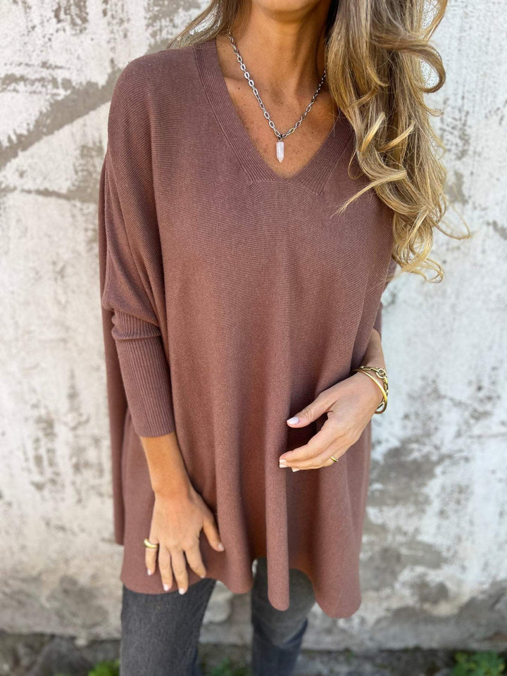 Relaxed fit women's V-neck swing tunic pullover sweater. Comfortable, versatile long sleeve top for effortless style.