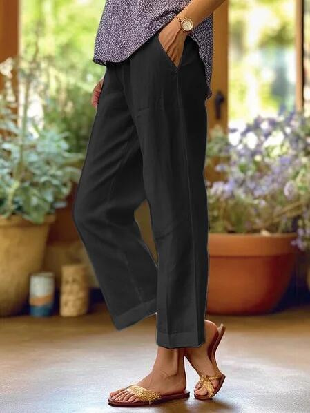 Stylish tapered women's cropped pants with cuffed hem, perfect for smart casual looks. Comfortable for summer fashion.