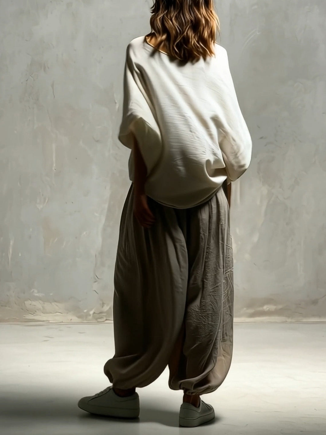 Flowing women's taupe wide leg harem pants, high-waisted with a relaxed fit, ideal for boho style & summer comfort.