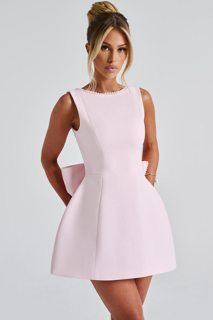 Women's special occasion A-line mini dress, stylishly designed with pearl trim and a chic statement bow.