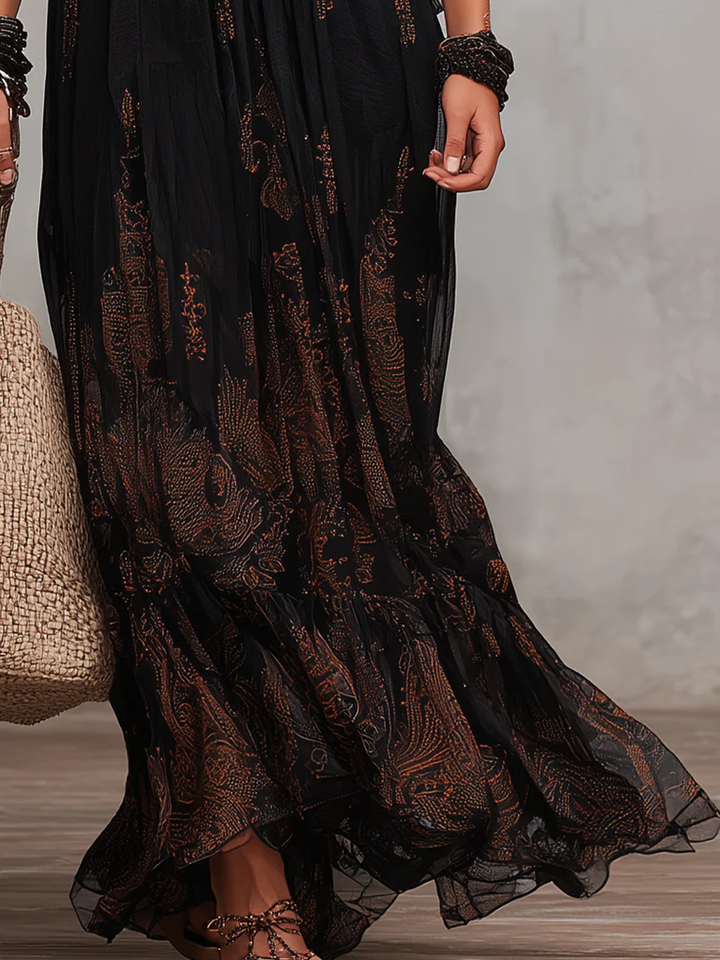 Comfortable black boho maxi dress with elegant flutter sleeves, lace trim, and tiered design, a stylish summer fashion choice.