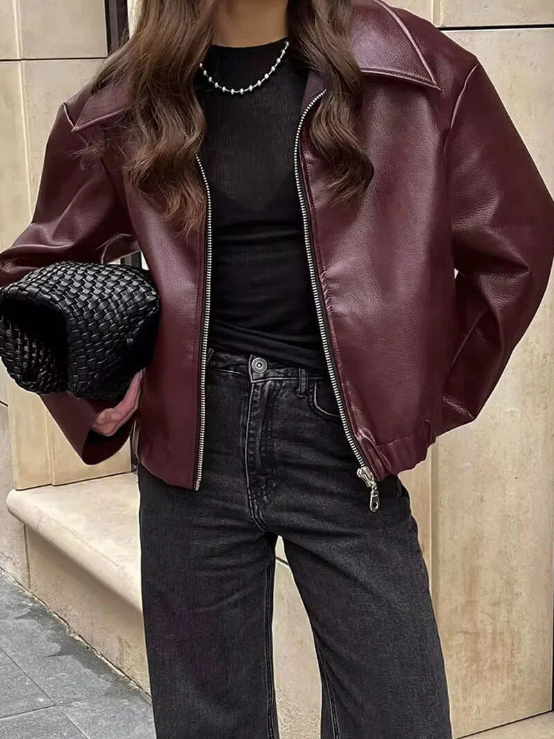 Women's elegant burgundy leather zipper jacket, perfect for chic autumn & spring fashion. Tailored fit for modern ladies.