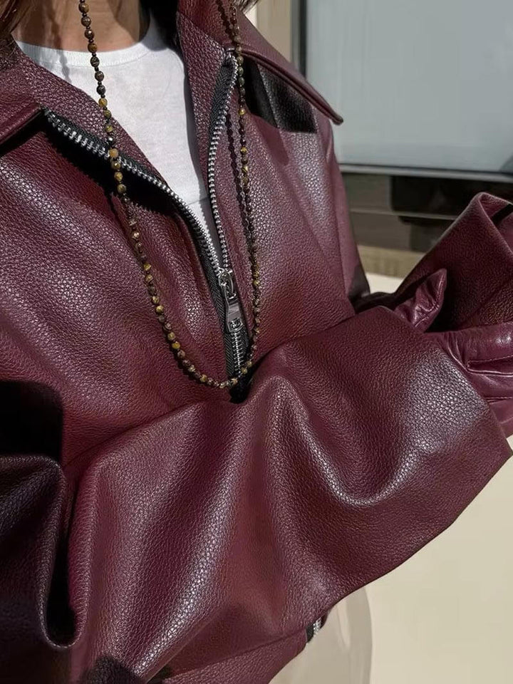 Elegant bordeaux red leather women's jacket with practical zipper. A versatile piece for ladies' spring and autumn style.