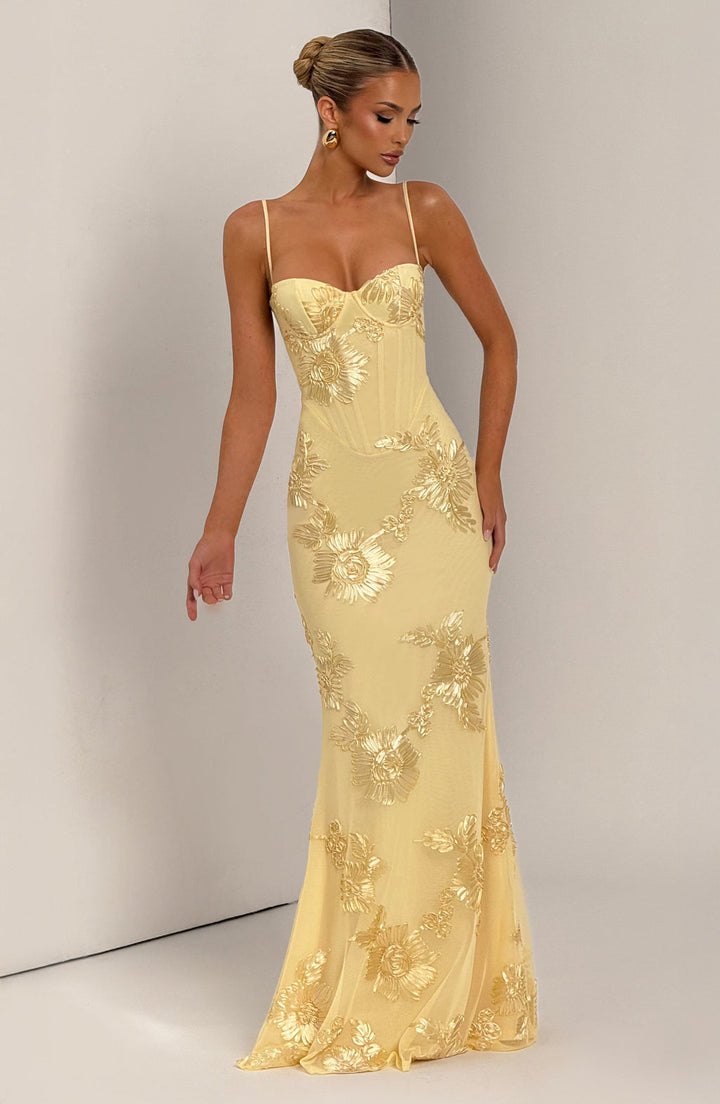 Elegant women's floral evening gown, a maxi dress with a refined corset, spaghetti straps & low back, suited for formal events.
