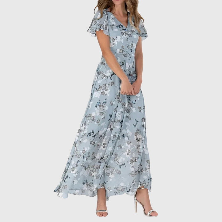 Flowy women's floral print maxi dress featuring a V-neck and flutter sleeves, ideal for a bohemian spring look.