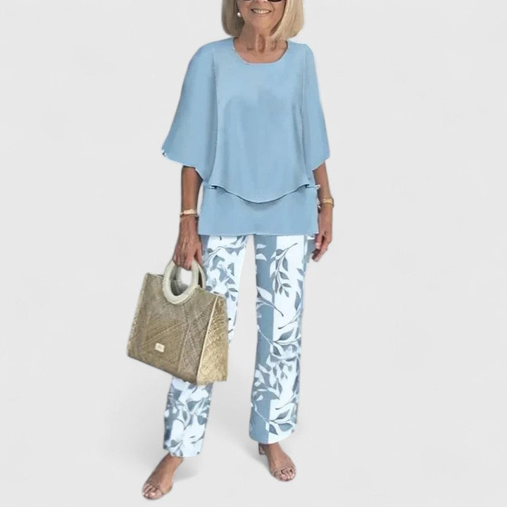 Modern women's elegant floral print two-piece set: chic layered top and wide leg trousers.