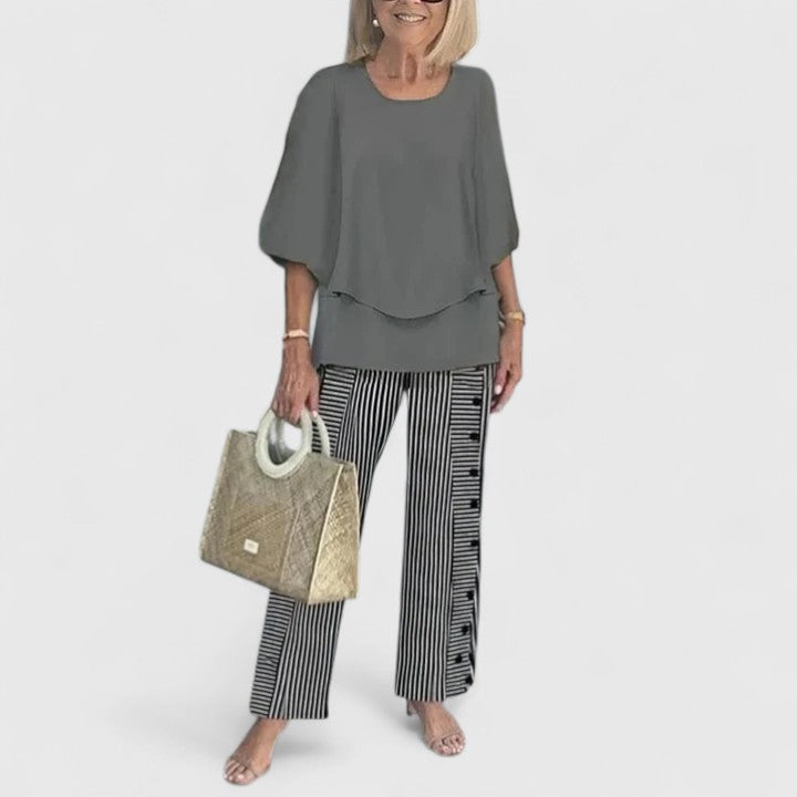 Sophisticated women's floral print two-piece set, featuring a layered top and elegant wide leg trousers.